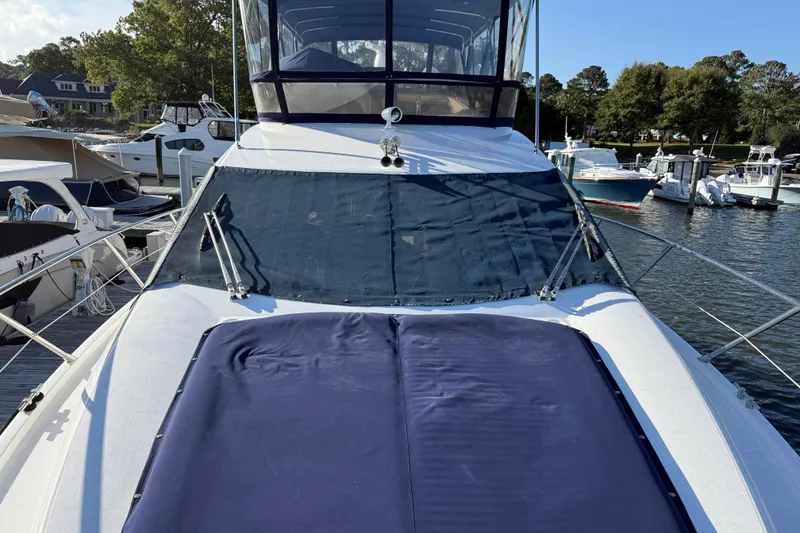 Slide: The Image of 2008 Sunseeker Manhattan 50 yacht docked at marina, featuring covered deck and windshield. - 12