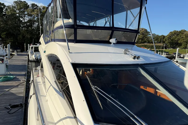 Slide: The Image of 2008 Sunseeker Manhattan 50 yacht docked at marina, featuring sleek design and spacious deck. - 14