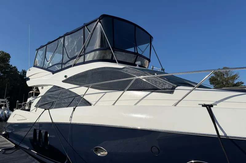 Slide: The Image of 2008 Sunseeker Manhattan 50 yacht with sleek design, docked under clear blue sky. - 17