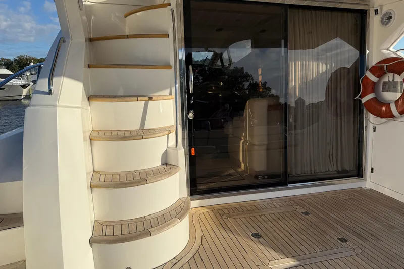 Slide: The Image of 2008 Sunseeker Manhattan 50 yacht deck with spiral staircase and sliding glass door. - 22