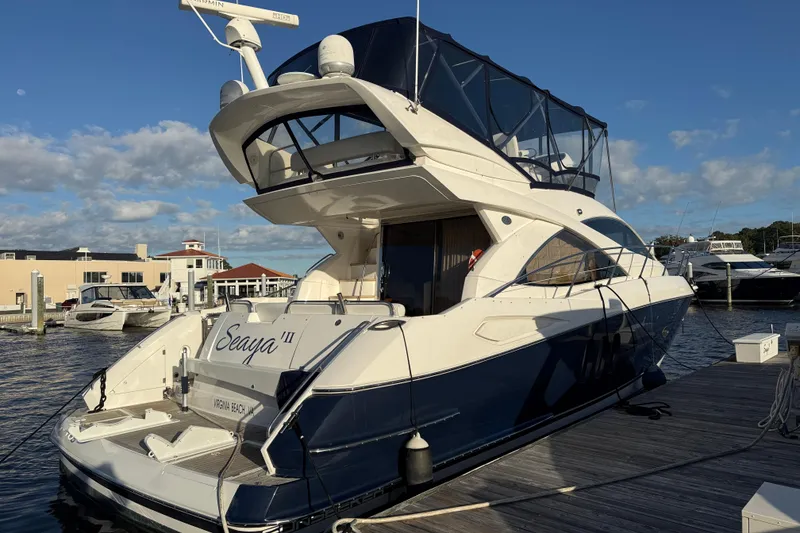 Slide: The Image of 2008 Sunseeker Manhattan 50 yacht docked at marina under clear sky. - 3