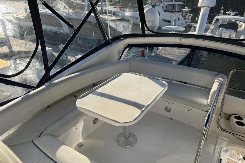 Slide: The Image of Luxurious 2008 Sunseeker Manhattan 50 yacht interior with seating and table, docked at marina. - 31