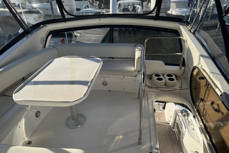 Slide: The Image of 2008 Sunseeker Manhattan 50 yacht interior with seating and table, docked at marina. - 32