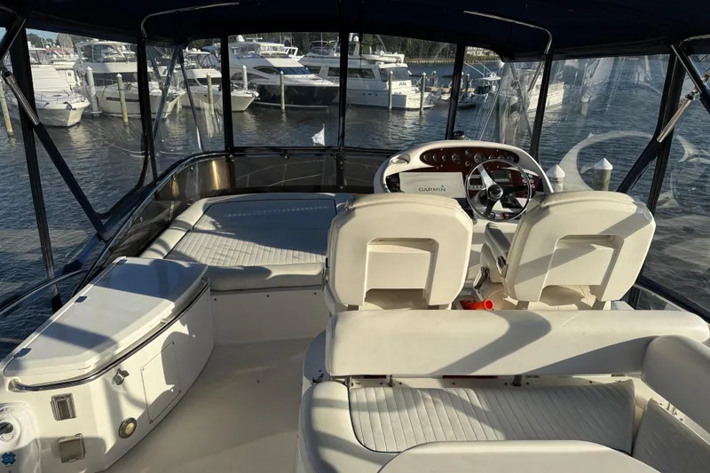 Slide: The Image of 2008 Sunseeker Manhattan 50 yacht cockpit with helm, seating, and marina view. - 33