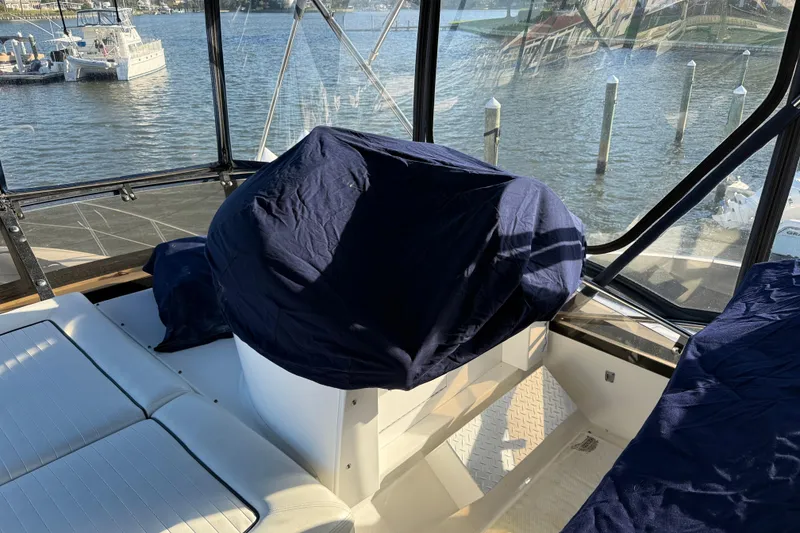 Slide: The Image of Interior of 2008 Sunseeker Manhattan 50 yacht with covered seating and water view. - 36