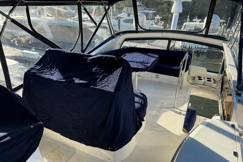 Slide: The Image of 2008 Sunseeker Manhattan 50 yacht interior with covered seating and helm station. - 37