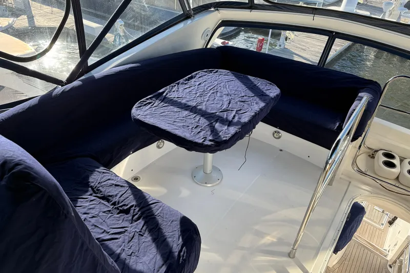 Slide: The Image of 2008 Sunseeker Manhattan 50 yacht interior with blue-covered seating and table. - 38