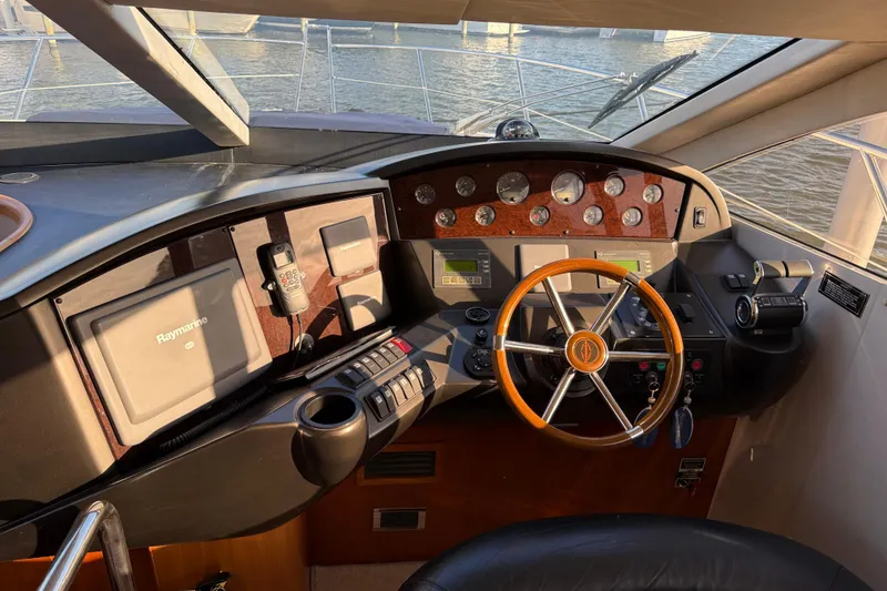 Slide: The Image of Helm of 2008 Sunseeker Manhattan 50 yacht with navigation equipment and wooden steering wheel. - 39