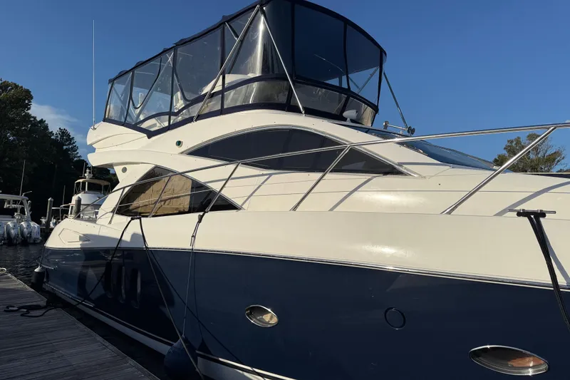 Slide: The Image of 2008 Sunseeker Manhattan 50 yacht docked, featuring sleek design and spacious upper deck. - 4