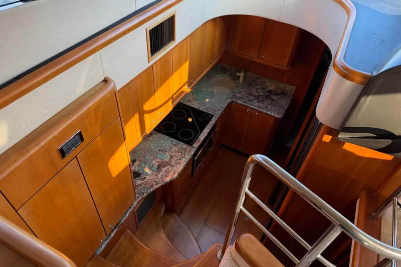 Slide: The Image of Luxurious 2008 Sunseeker Manhattan 50 yacht kitchen with wood cabinetry and modern appliances. - 48