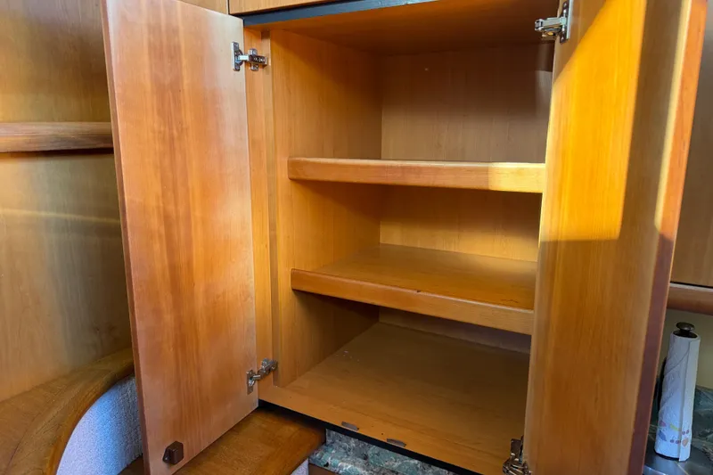 Slide: The Image of Open wooden cabinet with shelves inside Sunseeker Manhattan 50 yacht, 2008 model. - 51