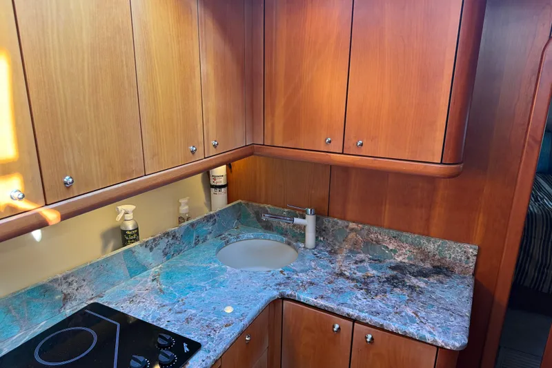 Slide: The Image of Luxurious 2008 Sunseeker Manhattan 50 yacht kitchen with wood cabinets and marble countertop. - 55