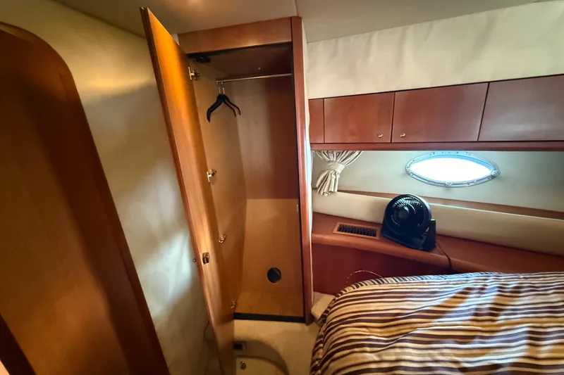 Slide: The Image of Interior of 2008 Sunseeker Manhattan 50 yacht with open closet and porthole window. - 59