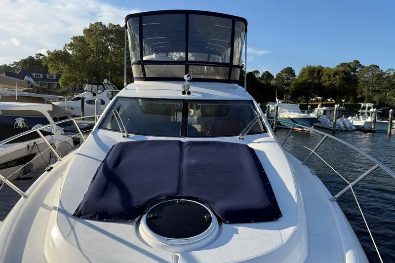 Slide: The Image of 2008 Sunseeker Manhattan 50 yacht docked at marina, featuring sleek design and spacious deck. - 6