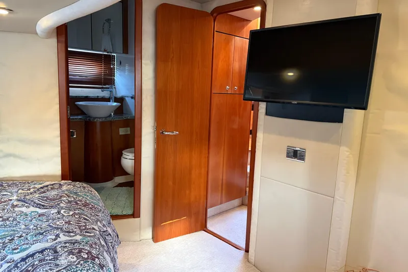 Slide: The Image of Luxurious 2008 Sunseeker Manhattan 50 yacht interior with bedroom, bathroom, and mounted TV. - 78