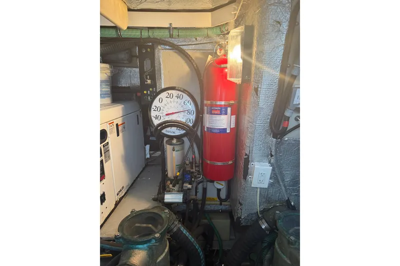 Slide: The Image of Engine room of 2008 Sunseeker Manhattan 50 yacht with fire extinguisher and temperature gauge. - 82