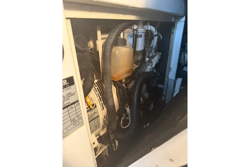 Slide: The Image of Engine compartment of 2008 Sunseeker Manhattan 50 yacht, featuring mechanical components and hoses. - 85