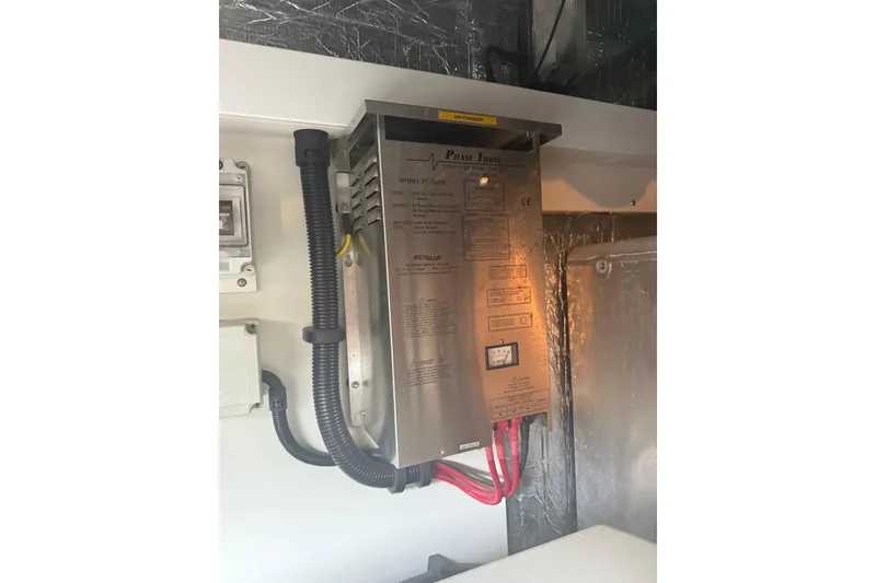 Slide: The Image of Electrical panel inside 2008 Sunseeker Manhattan 50 yacht, featuring wiring and controls. - 90