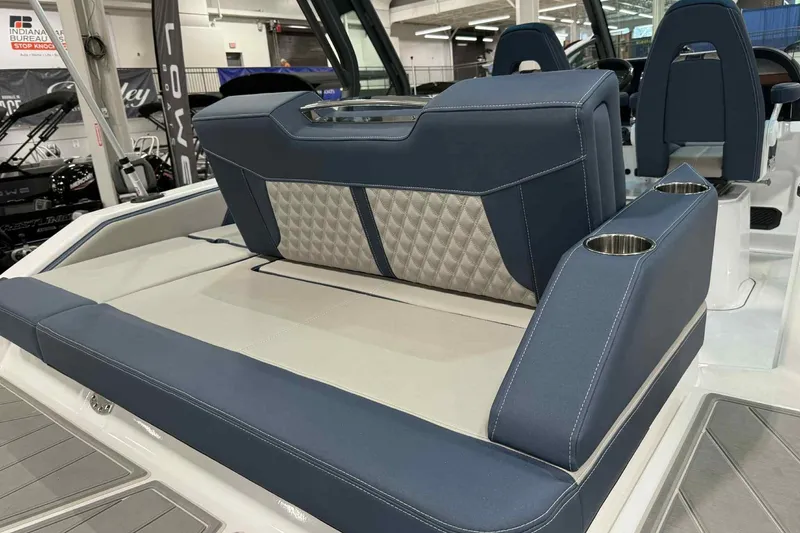 Slide: The Image of 2026 Monterey Elite 27 SD boat interior with blue seating and cup holders. - 12