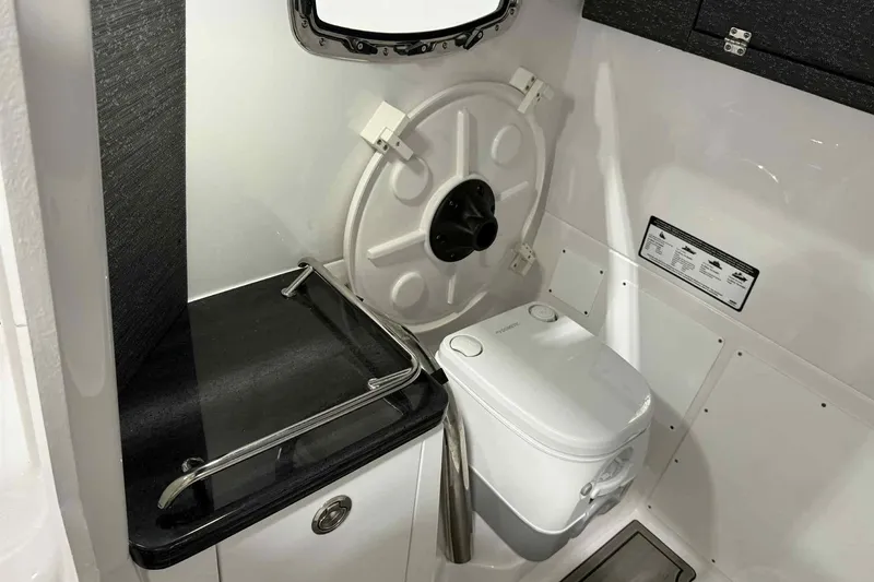 Slide: The Image of Interior of 2026 Monterey Elite 27 SD boat bathroom with toilet and sink. - 13