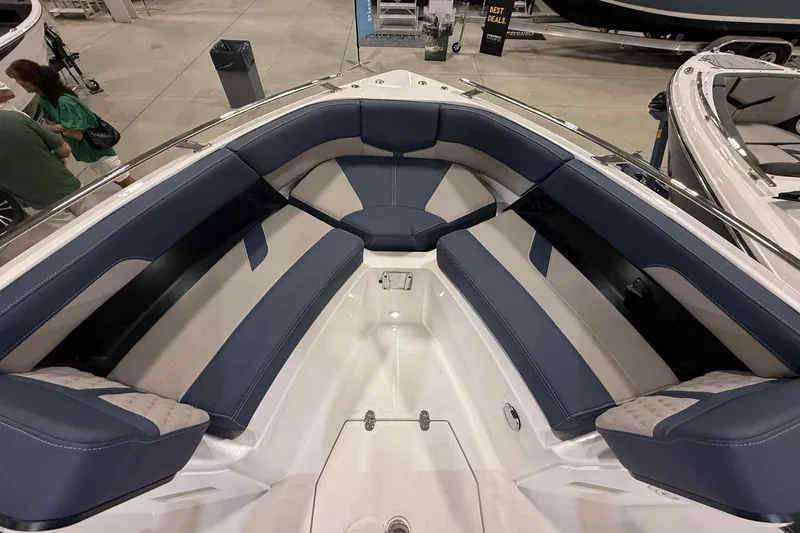 Slide: The Image of 2026 Monterey Elite 27 SD boat interior with blue and white seating at a showroom. - 15