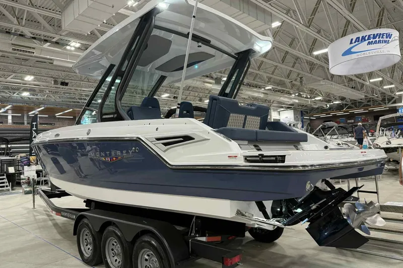 Slide: The Image of 2026 Monterey Elite 27 SD boat displayed indoors on a trailer at a marine showroom. - 5