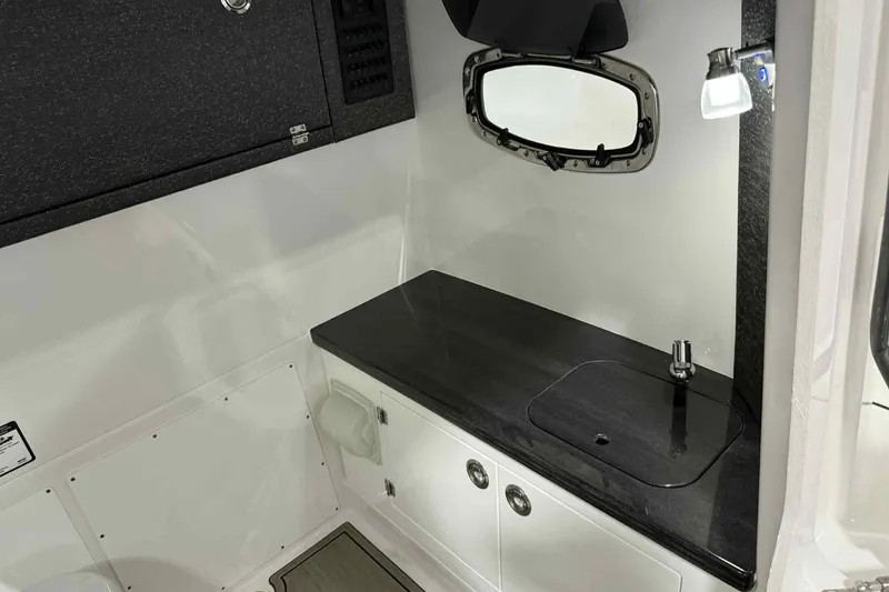 Slide: The Image of Interior of 2026 Monterey Elite 27 SD boat featuring sleek countertop and modern fixtures. - 8
