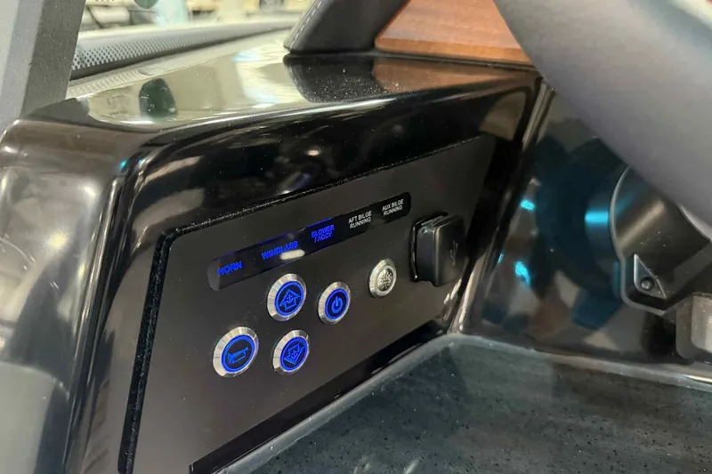 Slide: The Image of Control panel of 2026 Monterey Elite 27 SD boat with illuminated buttons. - 9