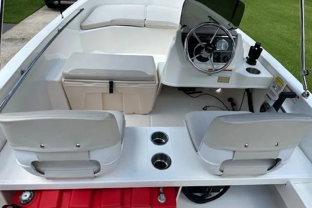 Slide: The Image of 2022 Boston Whaler 160 Super Sport interior with steering wheel and seating. - 17