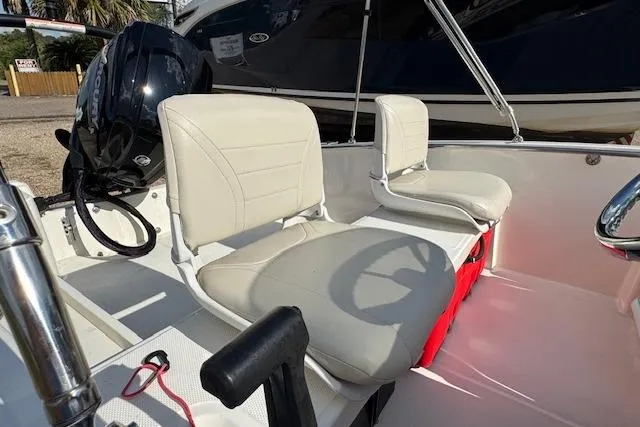 Slide: The Image of 2022 Boston Whaler 160 Super Sport interior with beige seating and Honda outboard motor. - 21