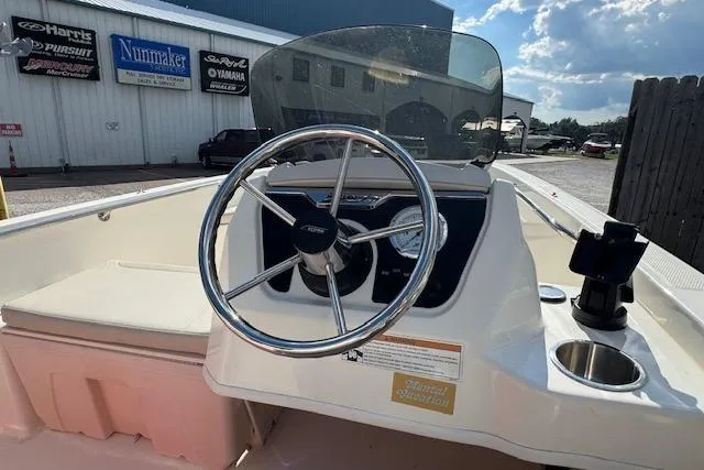 Slide: The Image of 2022 Boston Whaler 160 Super Sport boat dashboard with steering wheel and gauges. - 22