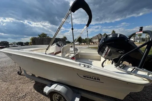 Slide: The Image of 2022 Boston Whaler 160 Super Sport boat on trailer, featuring a Mercury engine. - 4