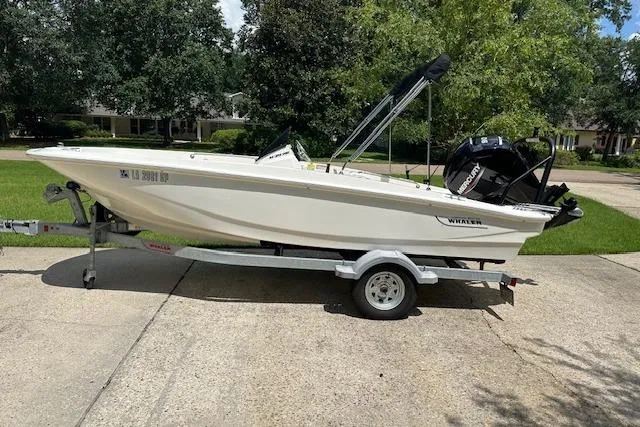 Slide: The Image of 2022 Boston Whaler 160 Super Sport boat on trailer, parked in a driveway. - 6