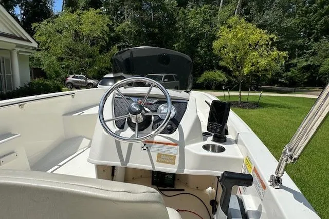 Slide: The Image of 2022 Boston Whaler 160 Super Sport boat interior with steering wheel and console. - 7
