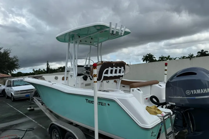 The Image of 2017 Tidewater 220 CC Adventure boat with Yamaha engine on trailer, under cloudy sky. - 0