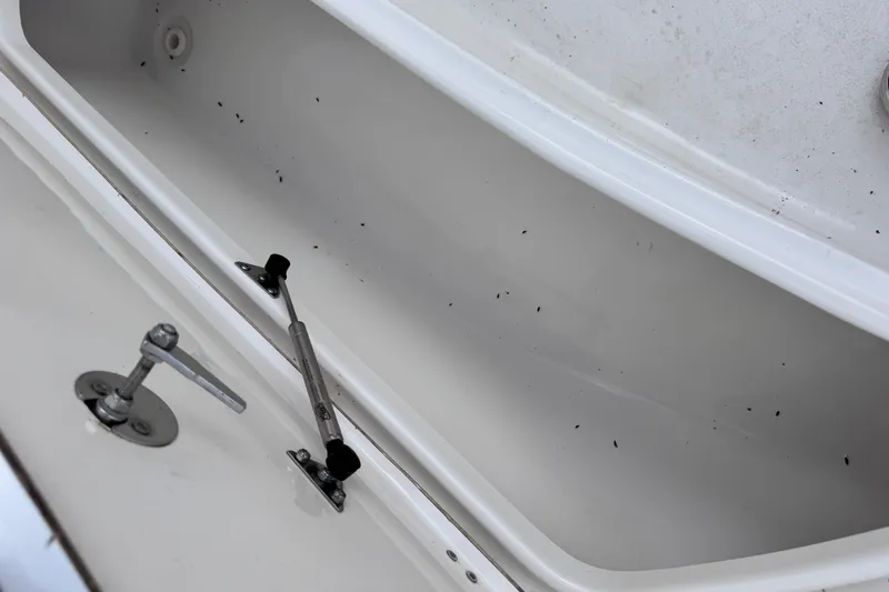 Slide: The Image of Open storage compartment of 2017 Tidewater 220 CC Adventure boat, showing interior details. - 15