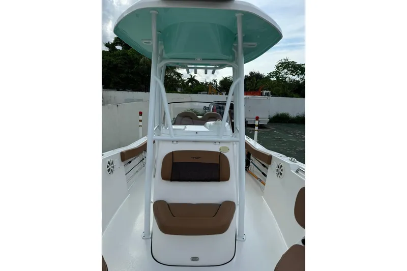Slide: The Image of 2017 Tidewater 220 CC Adventure boat interior with seating and T-top. - 2