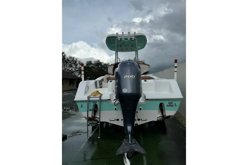 Slide: The Image of 2017 Tidewater 220 CC Adventure boat with Yamaha 200 outboard motor, parked outdoors. - 5