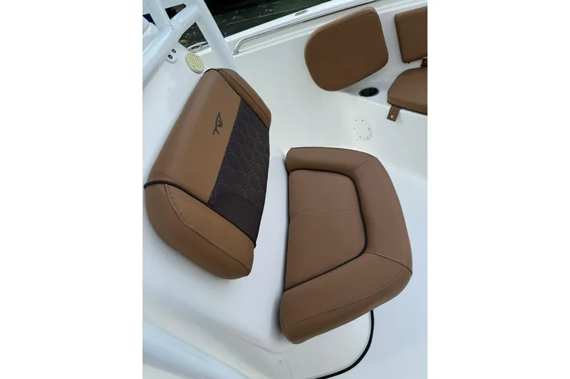 Slide: The Image of 2017 Tidewater 220 CC Adventure boat seat with brown upholstery and logo detail. - 6