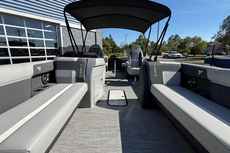 Slide: The Image of 2026 Viaggio X24U pontoon boat interior with gray seating and canopy. - 17