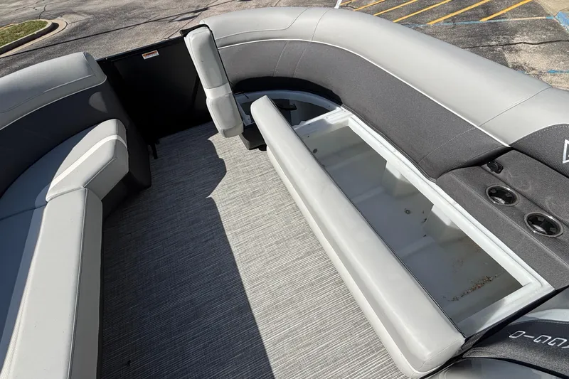 Slide: The Image of 2026 Viaggio X24U boat interior with open storage compartment and gray seating. - 27
