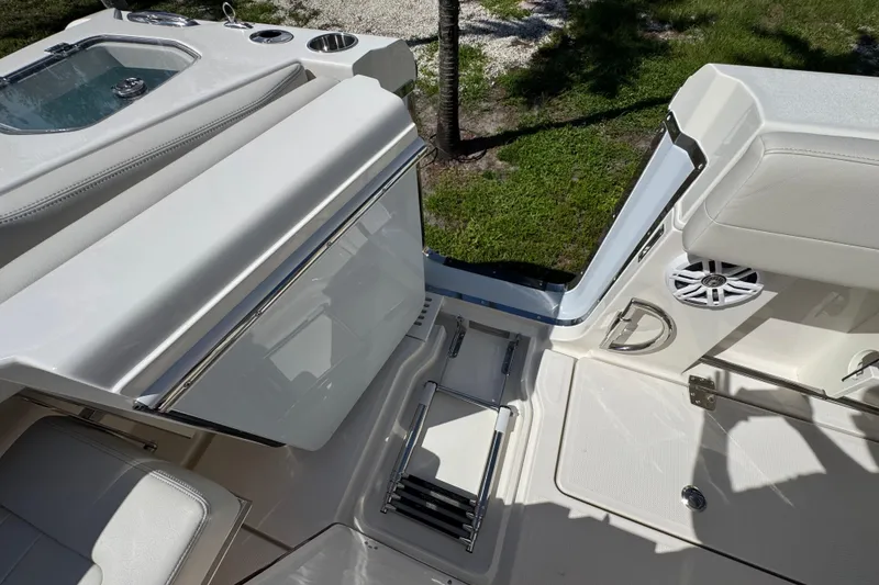Slide: The Image of 2026 Sailfish 360 CC boat interior with seating, storage, and speaker. - 10