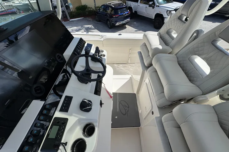 Slide: The Image of 2026 Sailfish 360 CC boat cockpit with modern steering and luxurious seating. - 13