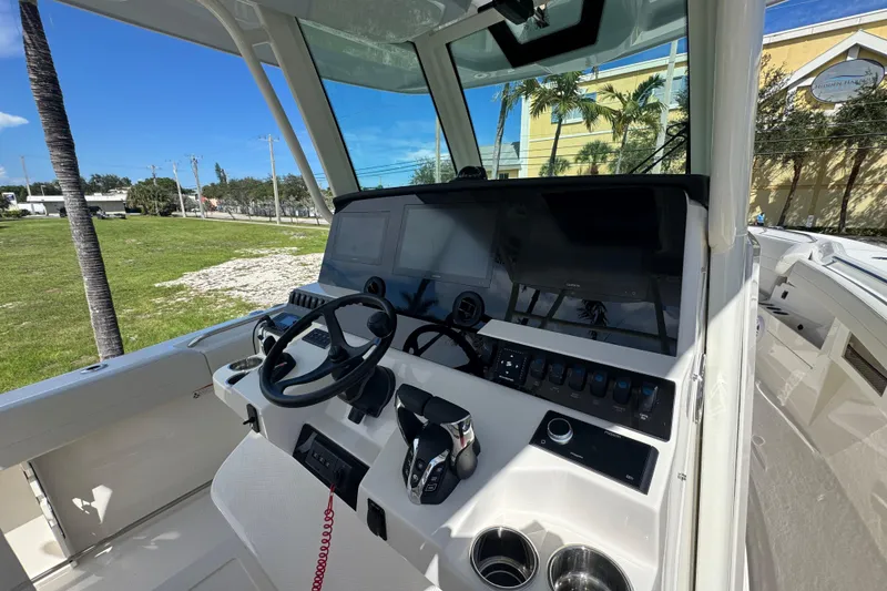 Slide: The Image of 2026 Sailfish 360 CC boat cockpit with modern steering and control panel. - 14
