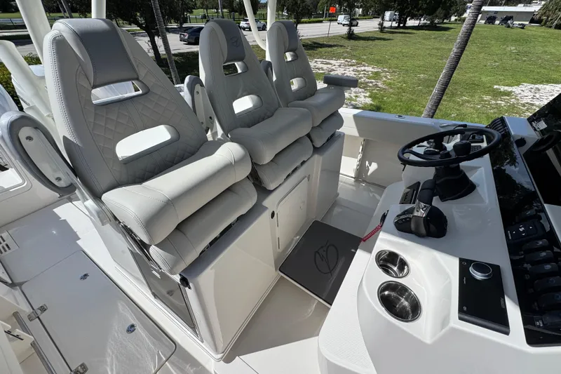 Slide: The Image of 2026 Sailfish 360 CC boat interior with luxurious seating and modern helm controls. - 18