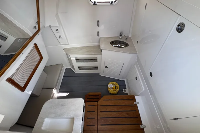 Slide: The Image of Interior of 2026 Sailfish 360 CC boat featuring modern sink and seating area. - 21