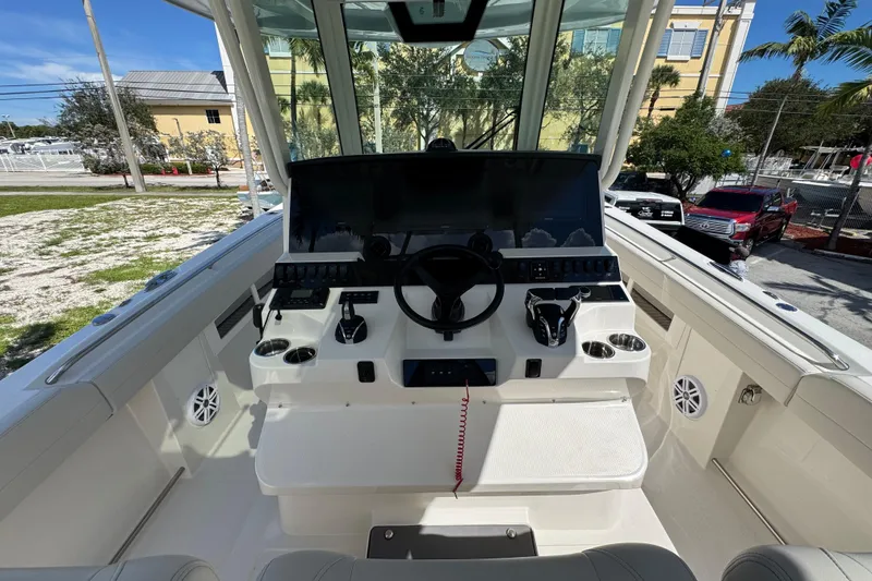 Slide: The Image of 2026 Sailfish 360 CC boat helm with modern controls and steering wheel. - 25
