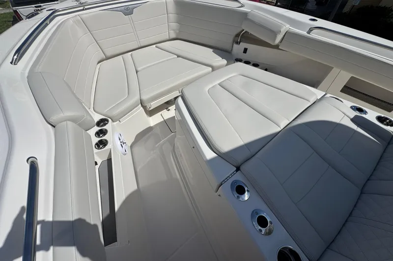 Slide: The Image of 2026 Sailfish 360 CC boat interior with luxurious white seating and cup holders. - 29
