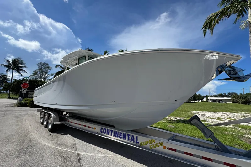 Slide: The Image of 2026 Sailfish 360 CC boat on trailer under clear blue sky. - 6