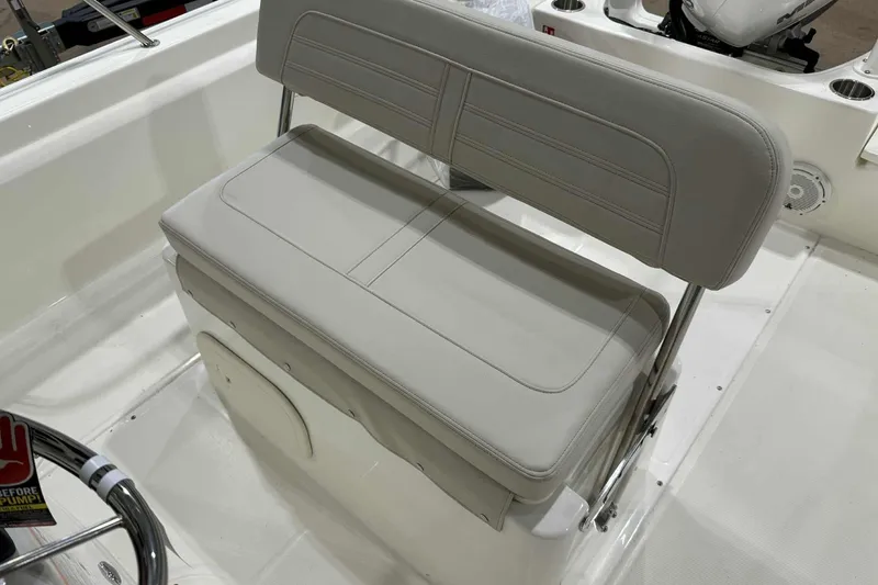 Slide: The Image of 2026 Boston Whaler 190 Montauk boat seat, featuring sleek white upholstery and stainless steel frame. - 11